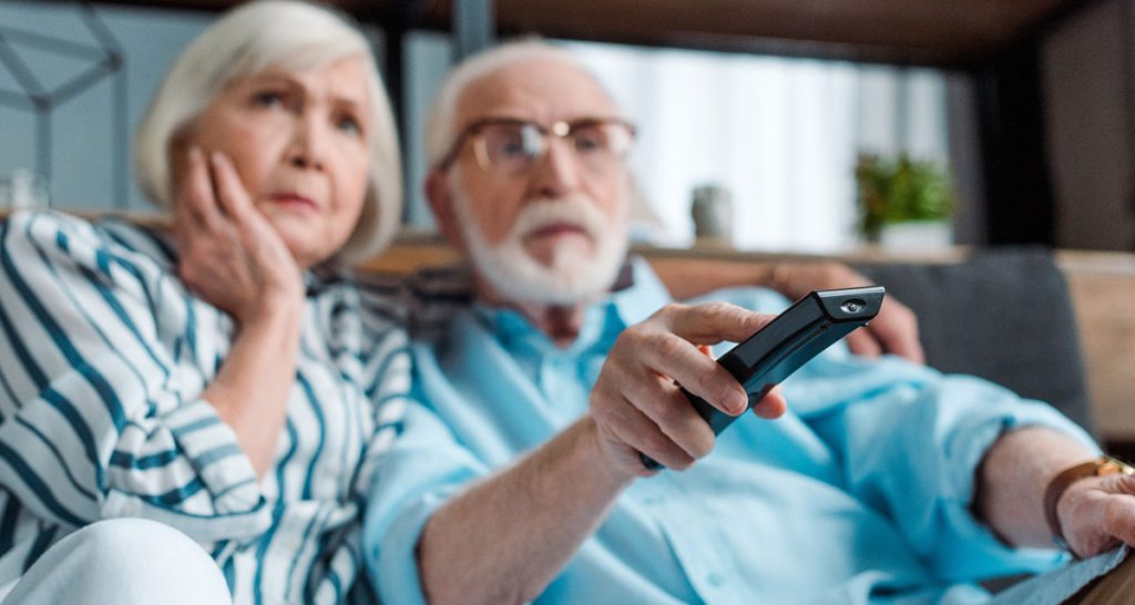 Couple watching 4 Corners on TV