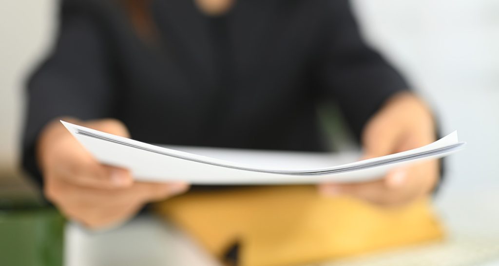 Woman with media release from Community Mental Health Australia