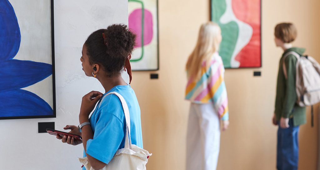 Woman looking at art exhibition for Mental Health Week